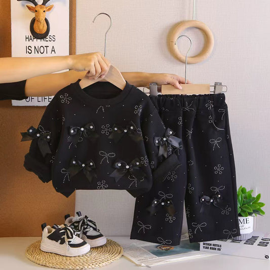 Meisjes setje met strikjes & wijduitlopende broek – lief & trendy 🎀✨